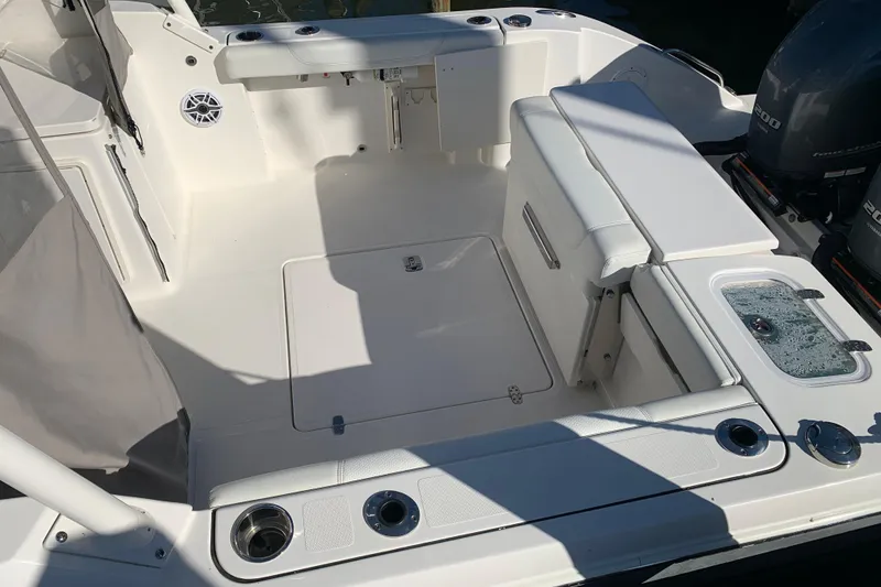 Slide: The Image of 2023 Pursuit DC 266 Dual Console boat interior with seating and storage features. - 6