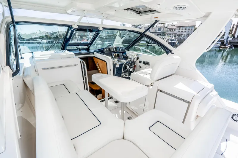 Slide: The Image of Interior of a 2005 Tiara Yachts 3600 Open with luxurious white seating. - 23