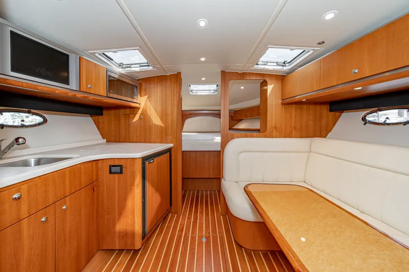 Slide: The Image of Interior of 2005 Tiara Yachts 3600 Open, featuring wood finish and seating area. - 38