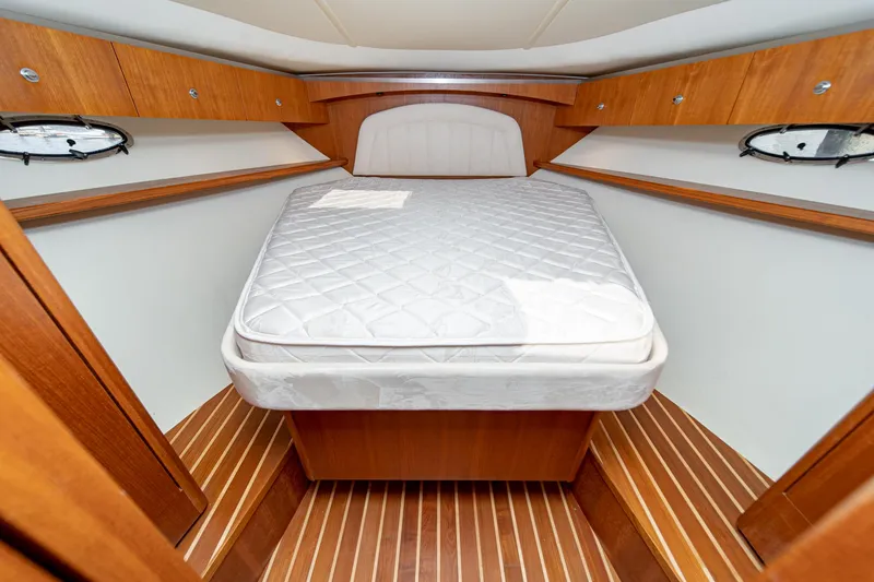 Slide: The Image of 2005 Tiara Yachts 3600 Open interior with bed and wood paneling. - 40