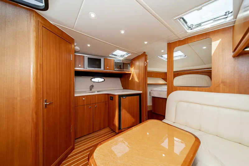 Slide: The Image of Interior of 2005 Tiara Yachts 3600 Open with kitchen and seating area. - 49