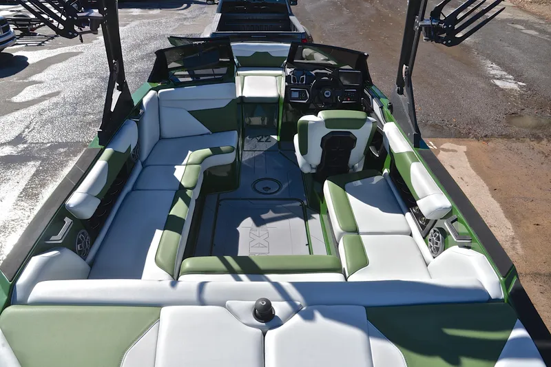 Slide: The Image of 2022 Axis A22 boat interior with green and white seating, modern dashboard. - 18