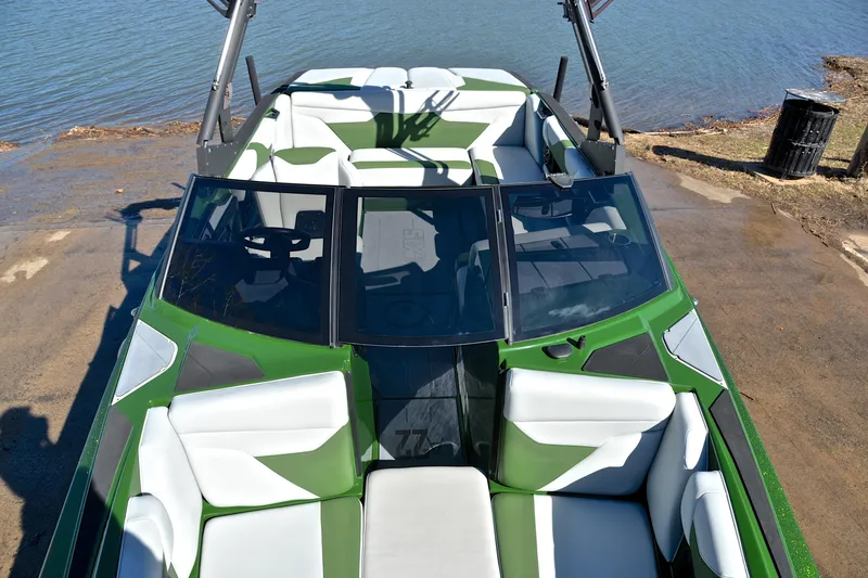 Slide: The Image of 2022 Axis A22 boat with green and white interior, docked by the water. - 20