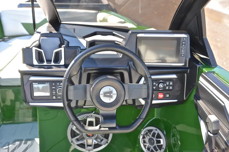 Slide: The Image of 2022 Axis A22 boat dashboard with steering wheel and navigation controls. - 27