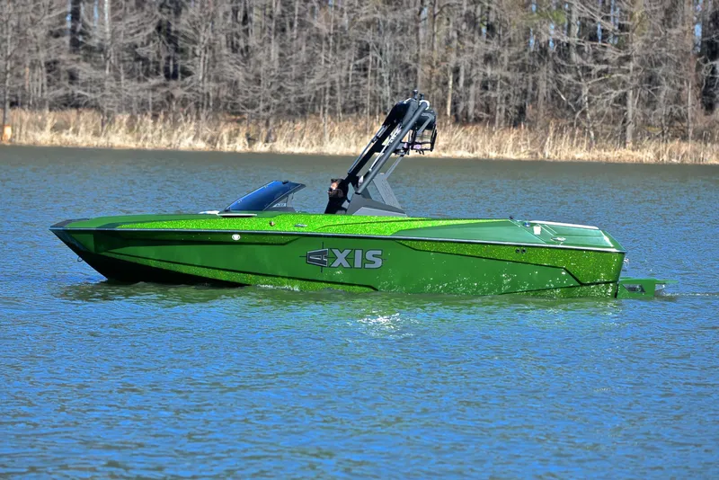 Slide: The Image of 2022 Axis A22 boat in vibrant green on a calm lake. - 9