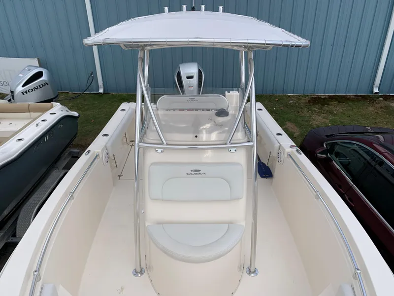 Slide: The Image of Cobia 237 Center Console boat, 2020 model, featuring T-top and helm station. - 2