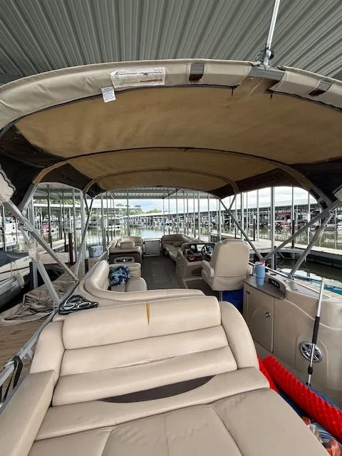 Slide: The Image of Interior view of a 2017 Regency 254 DL3 pontoon boat in a marina. - 3