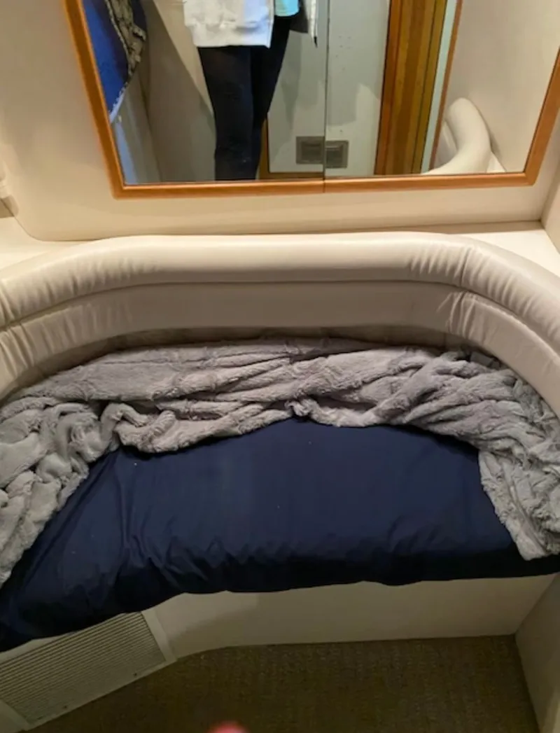 Slide: The Image of Interior of 1996 Sea Ray 440 Express Bridge with bed and mirror. - 17
