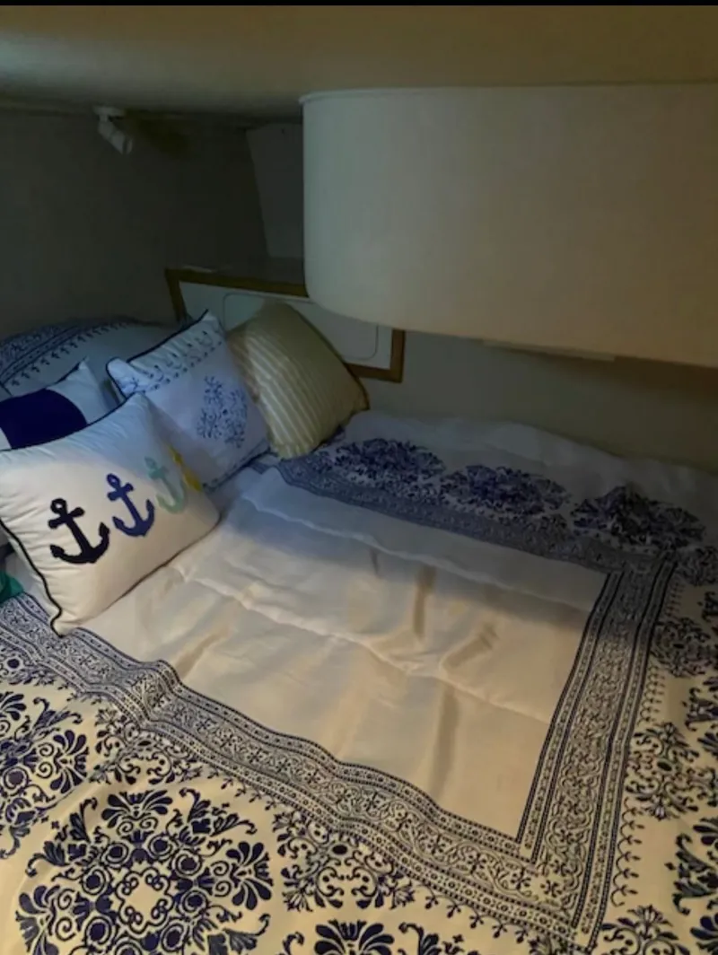 Slide: The Image of Interior of 1996 Sea Ray 440 Express Bridge with nautical bedding. - 18