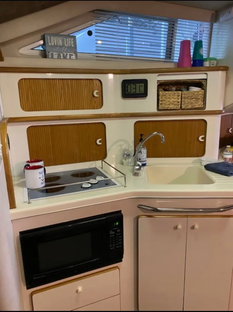 Slide: The Image of Kitchen area on a 1996 Sea Ray 440 Express Bridge boat. - 19