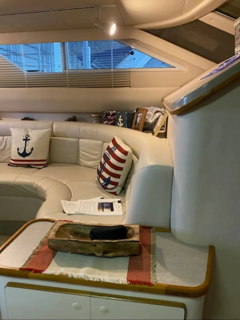 Slide: The Image of Interior of a 1996 Sea Ray 440 Express Bridge with nautical-themed pillows. - 22