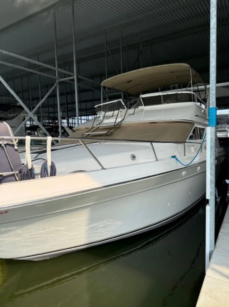 Slide: The Image of 1996 Sea Ray 440 Express Bridge docked in marina. - 3