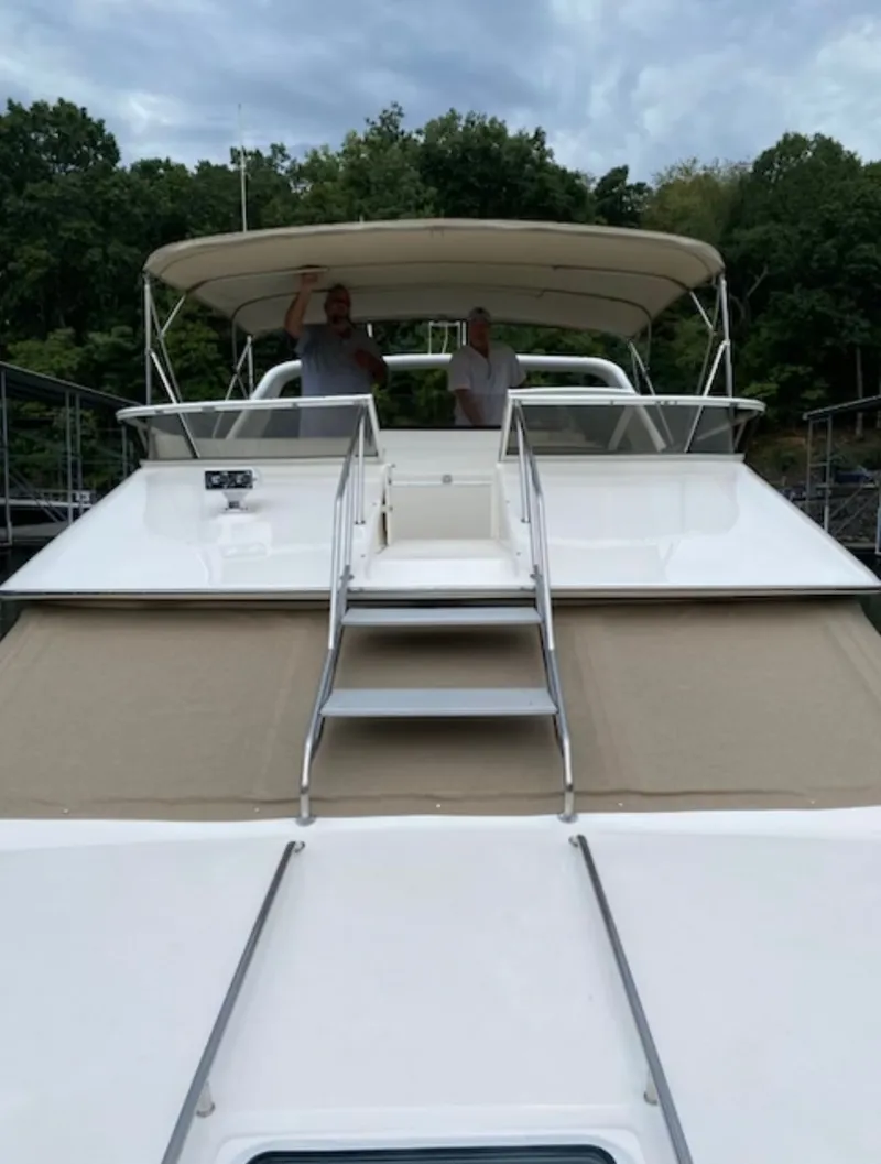 Slide: The Image of 1996 Sea Ray 440 Express Bridge with two people on board. - 4