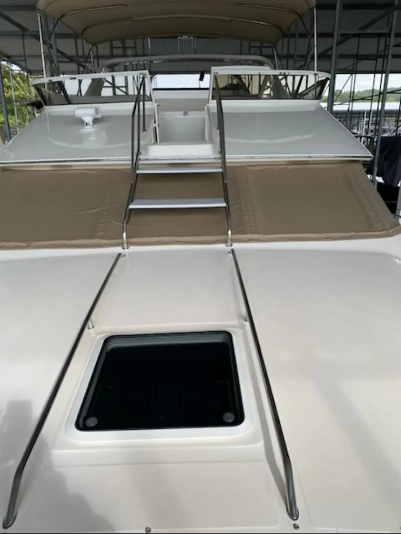 Slide: The Image of 1996 Sea Ray 440 Express Bridge with sun deck and ladder. - 6