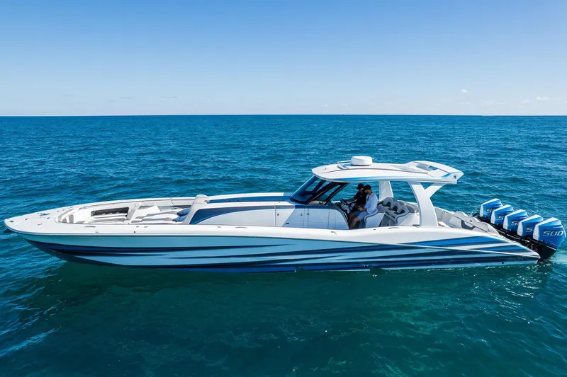 Slide: The Image of 2023 MTI 50v boat on open ocean, featuring sleek design and powerful engines. - 2