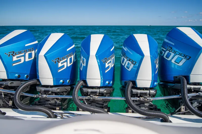 Slide: The Image of Five blue Racing 500 outboard motors on a 2023 MTI 50v boat. - 24