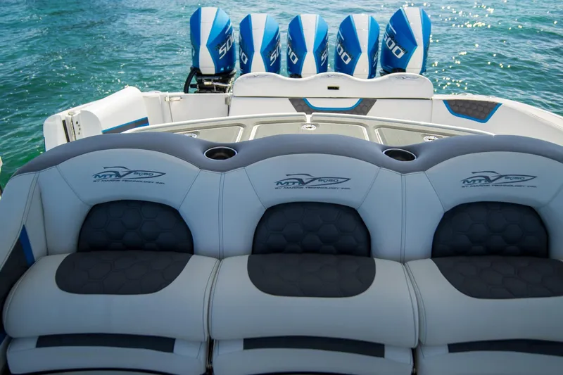 Slide: The Image of Luxury MTI 50v boat interior with quad engines, 2023 model, on clear blue water. - 33