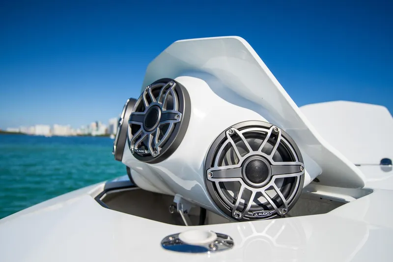 Slide: The Image of 2023 MTI 50v boat with JL Audio speakers, ocean backdrop, clear blue sky. - 38