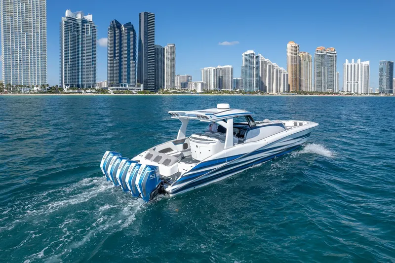 Slide: The Image of 2023 MTI 50v boat cruising near city skyline on a sunny day. - 44