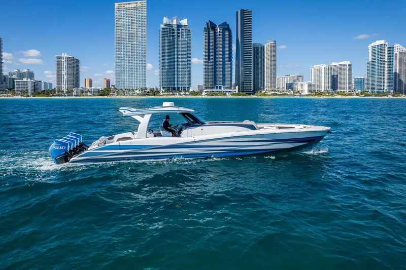 Slide: The Image of 2023 MTI 50v boat cruising near city skyline on a sunny day. - 45