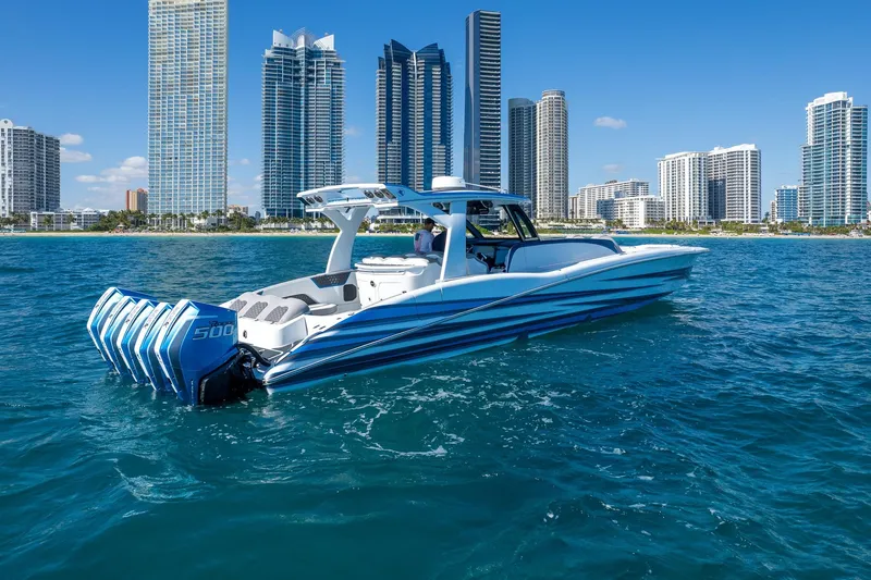 Slide: The Image of 2023 MTI 50v boat cruising near city skyline, featuring multiple powerful engines. - 46