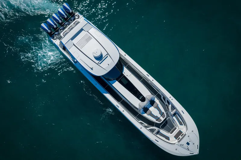 Slide: The Image of Aerial view of 2023 MTI 50v boat cruising on clear blue water. - 50