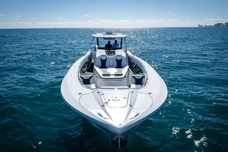Slide: The Image of 2023 MTI 50v boat cruising on open ocean under clear blue sky. - 51