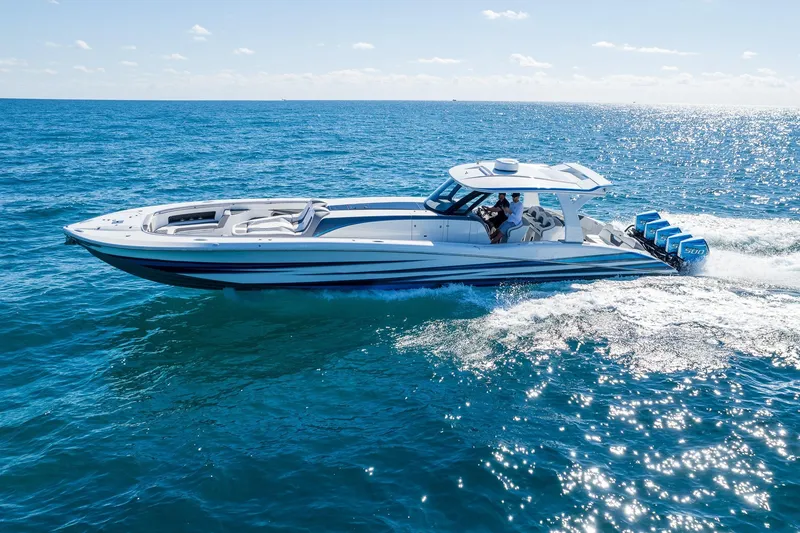 Slide: The Image of 2023 MTI 50v boat cruising on open ocean with clear blue skies. - 55
