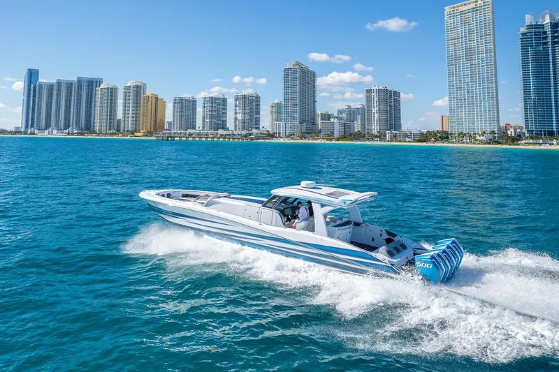 Slide: The Image of 2023 MTI 50v boat cruising near city skyline on a sunny day. - 57