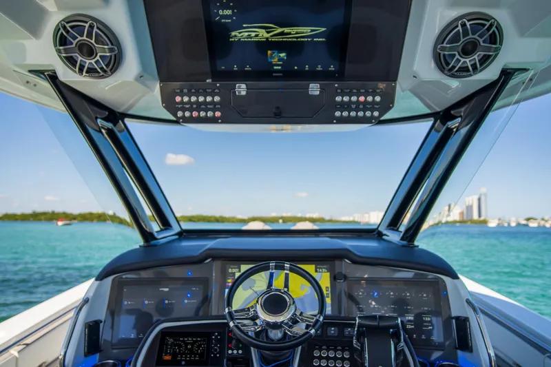 Slide: The Image of Cockpit view of 2023 MTI 50v boat with advanced navigation system and ocean backdrop. - 8