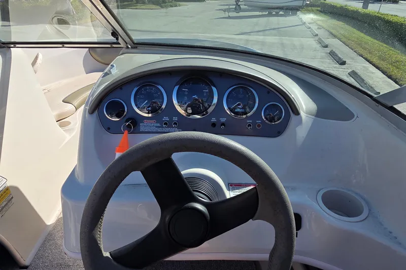 Slide: The Image of Dashboard view of a 2004 Sea Ray 200 Sport boat with steering wheel and gauges. - 6