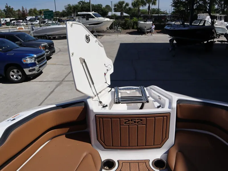 Slide: The Image of Yamaha Boats 252SE 2026 with open storage and brown seating. - 17