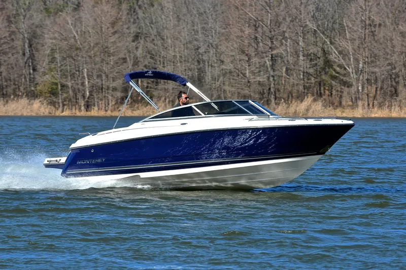 The Image of 2011 Monterey 234FS boat cruising on a lake with forested background. - 0