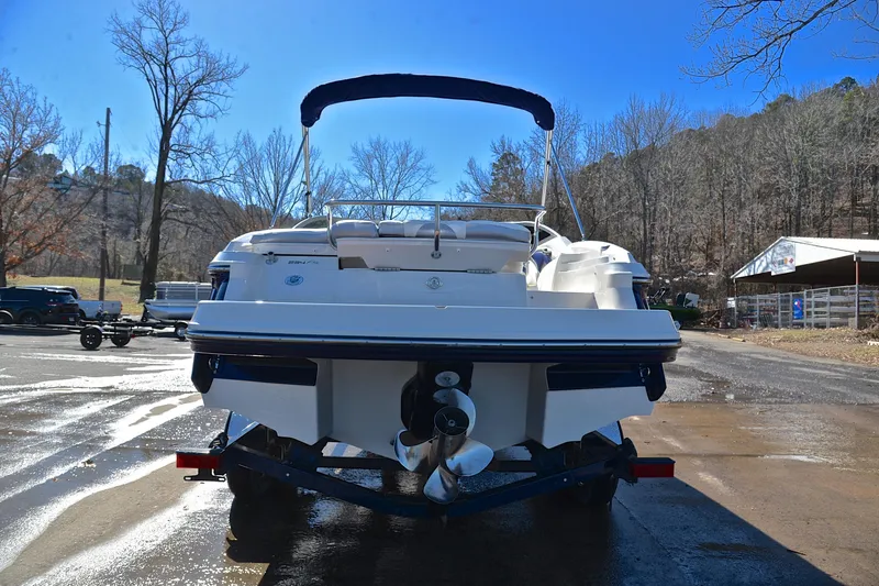 Slide: The Image of 2011 Monterey 234FS boat on trailer, parked outdoors on a sunny day. - 12
