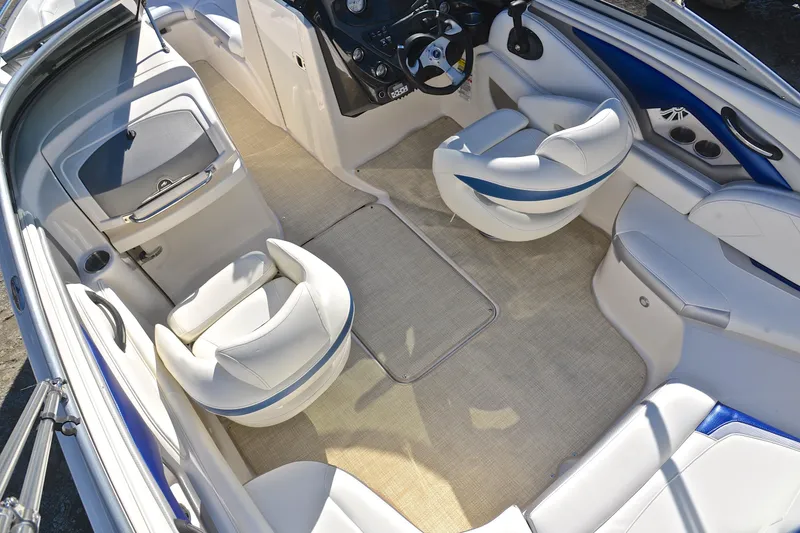 Slide: The Image of 2011 Monterey 234FS boat interior with white seating and beige flooring. - 21