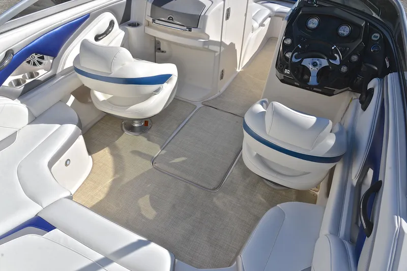 Slide: The Image of Interior of a 2011 Monterey 234FS boat with white and blue seating. - 22