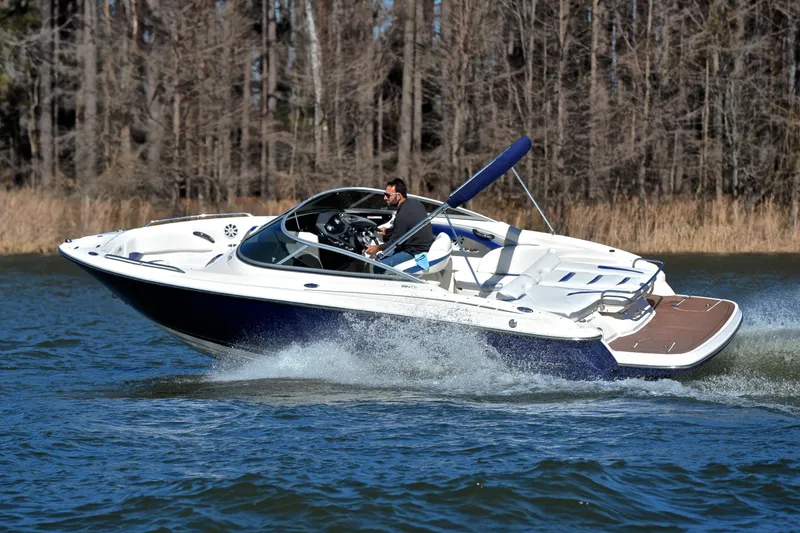 Slide: The Image of 2011 Monterey 234FS boat cruising on a lake with trees in the background. - 5