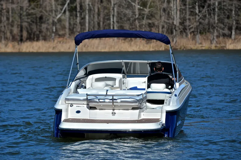 Slide: The Image of 2011 Monterey 234FS boat cruising on a lake with a canopy. - 7