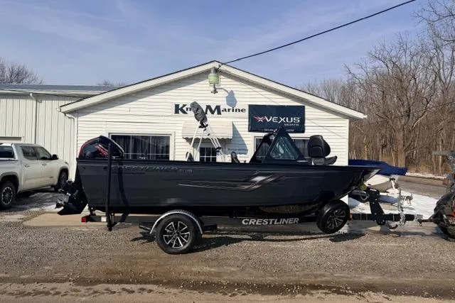 The Image of 2026 Crestliner 1850 Commander boat on trailer outside marine dealership. - 0