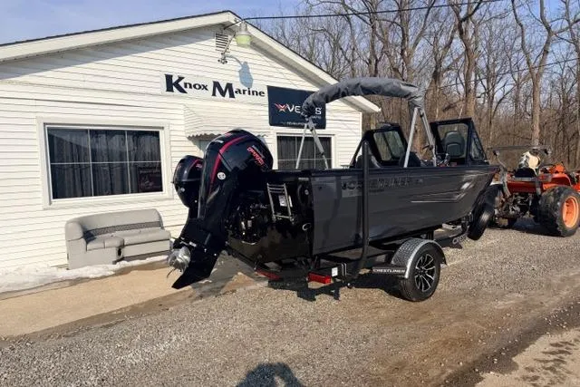 Slide: The Image of 2026 Crestliner 1850 Commander boat at Knox Marine dealership, parked on gravel. - 2