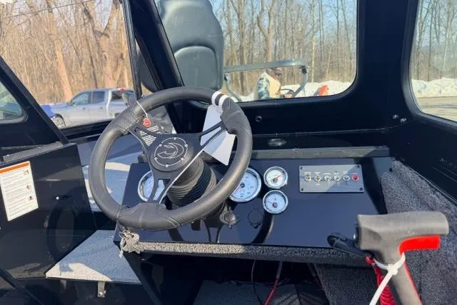 Slide: The Image of 2026 Crestliner 1850 Commander boat dashboard with steering wheel and gauges. - 4
