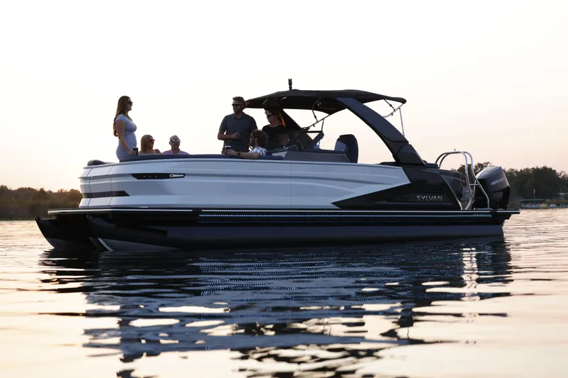 The Image of 2025 Sylvan M5 CLZ DC pontoon boat with people enjoying a sunset cruise. - 0