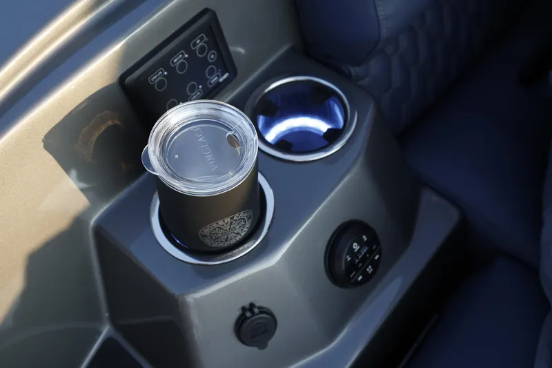 Slide: The Image of Cup holder and control panel in 2025 Sylvan M5 CLZ DC boat interior. - 21
