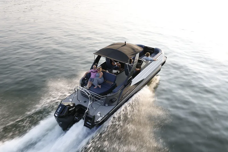 Slide: The Image of 2025 Sylvan M5 CLZ DC boat cruising on open water with passengers enjoying the ride. - 27