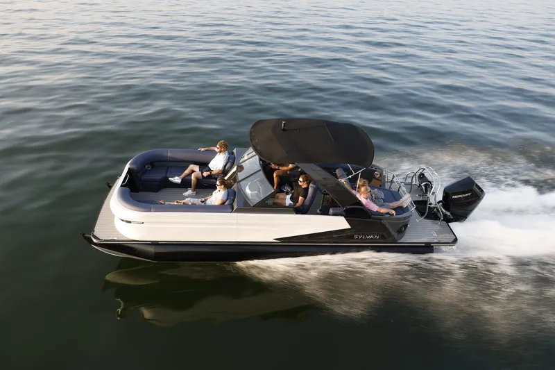 Slide: The Image of 2025 Sylvan M5 CLZ DC pontoon boat cruising on open water with passengers. - 7