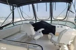 Slide: The Image of 1997 Bayliner 3587 Motoryacht interior with seating and helm, featuring panoramic windows. - 4