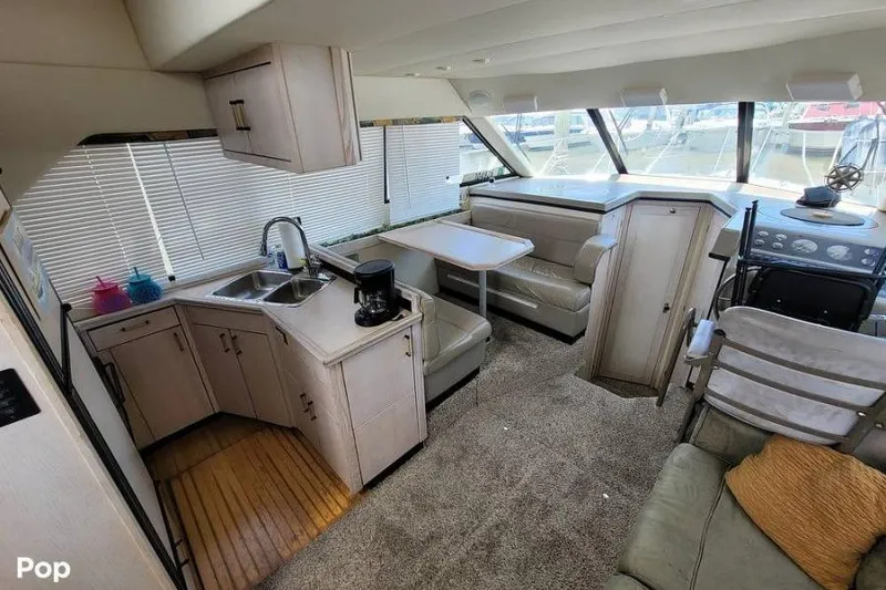 Slide: The Image of Interior of 1997 Bayliner 3587 Motoryacht with kitchen, seating, and helm station. - 5