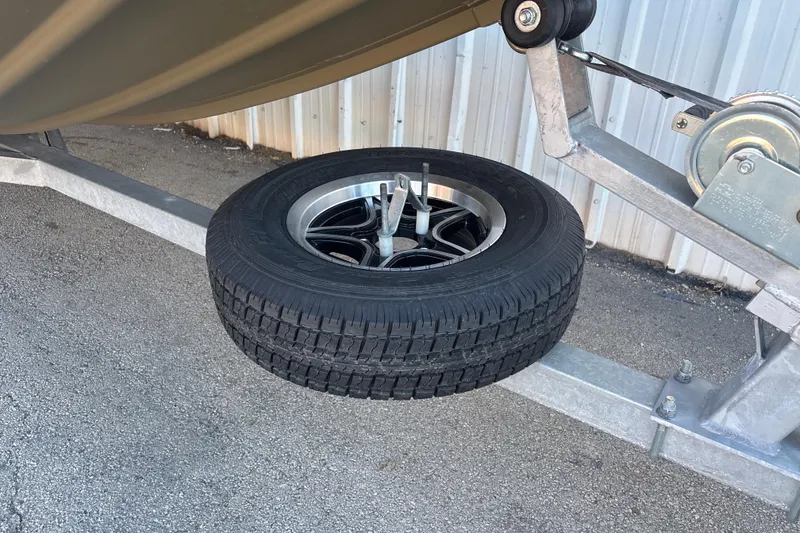 Slide: The Image of 2025 G3 Gator Tough 1652 VBW trailer with spare tire mounted on metal frame. - 11