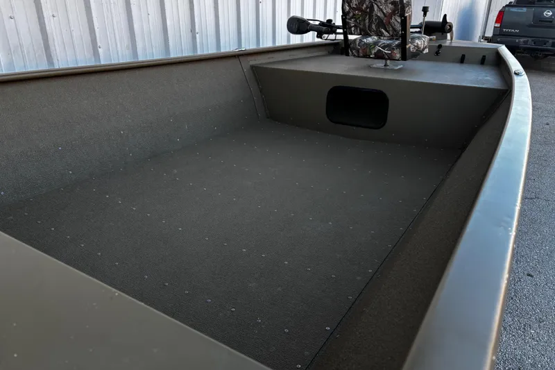 Slide: The Image of 2025 G3 Gator Tough 1652 VBW boat interior with camo seat and spacious deck. - 36