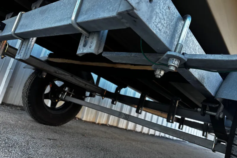 Slide: The Image of Underneath view of 2025 G3 Gator Tough 1652 VBW trailer, showcasing suspension and wheel. - 41